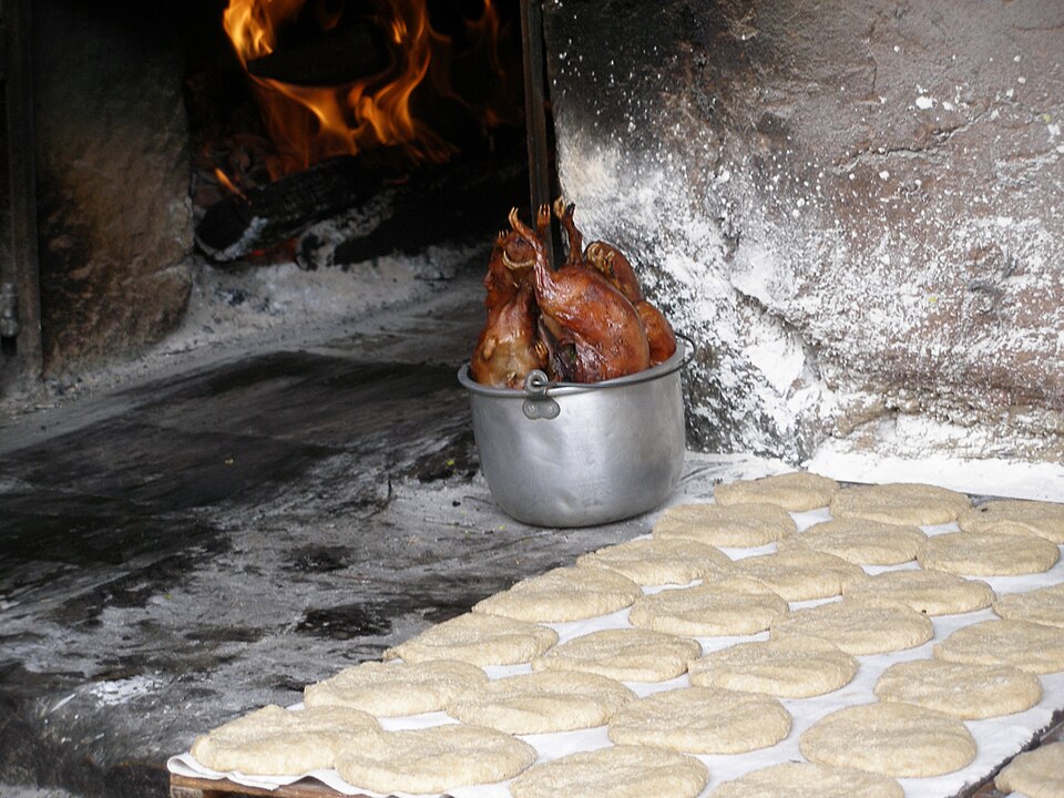A roasted cuy or guinea pig served whole on a plate, a traditional dish in the Peruvian Andes