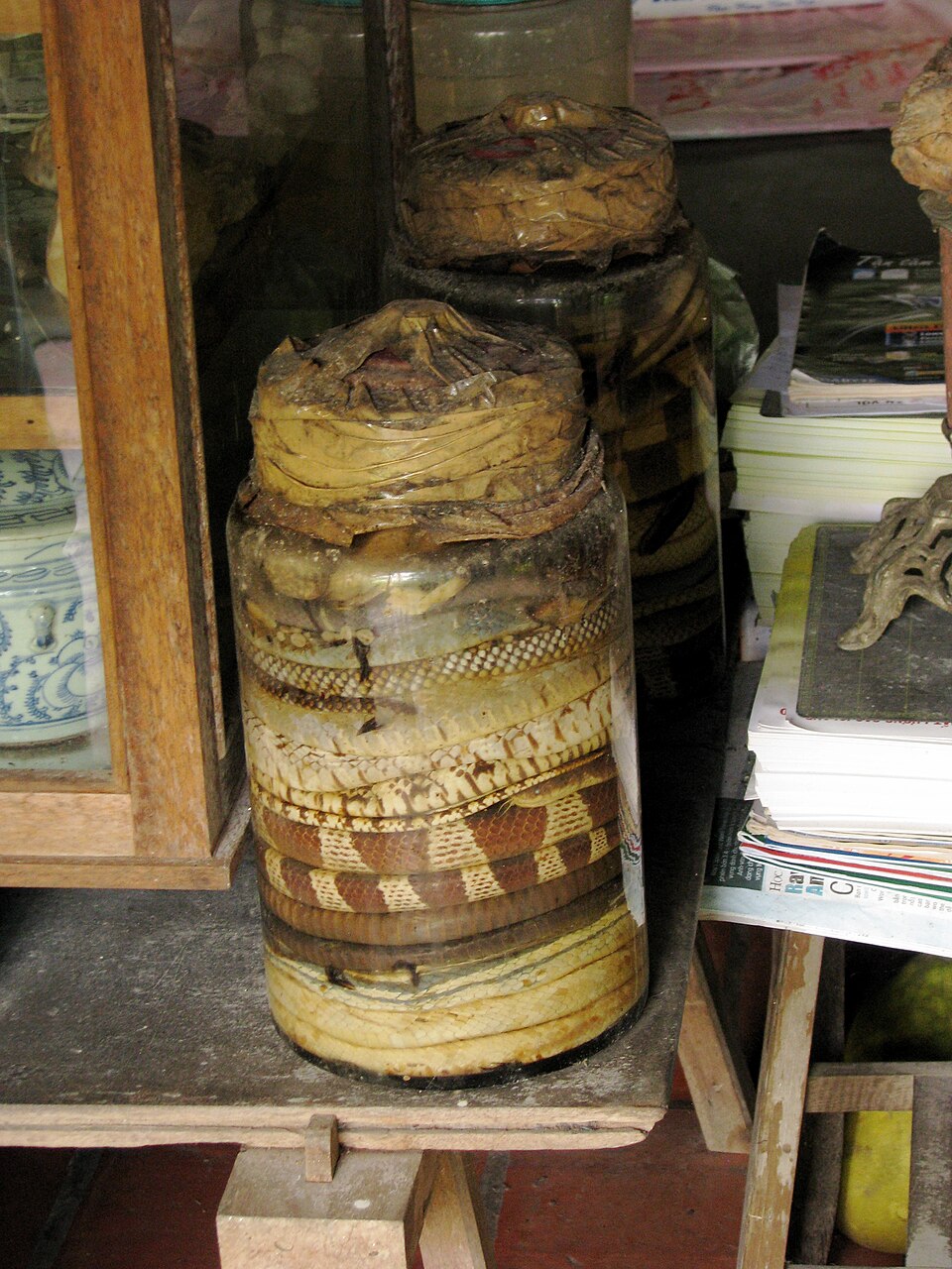A glass of Vietnamese snake wine with a preserved cobra inside the bottle