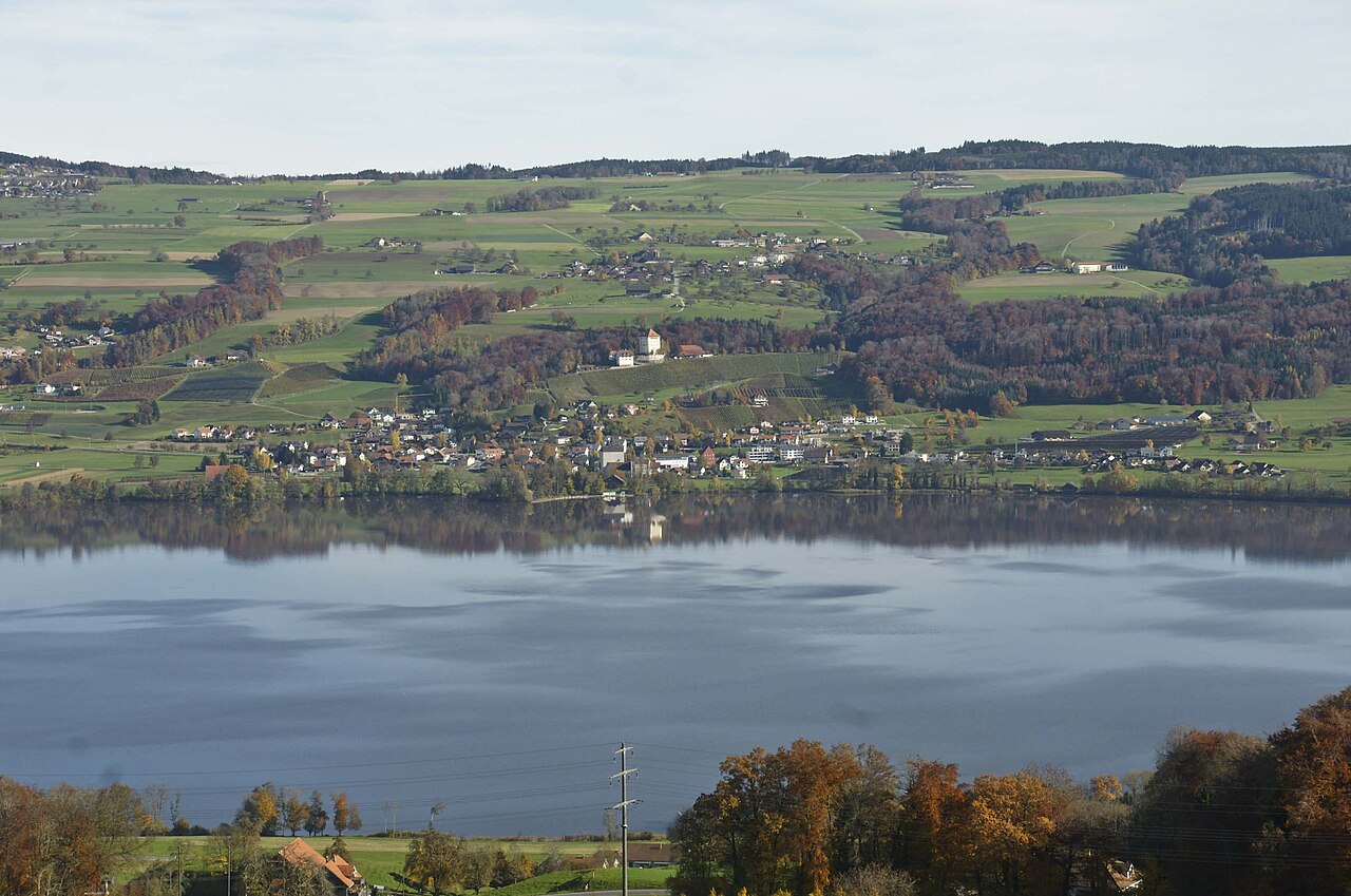 Lake Baldegg and the village of Gelfingen in the Seetal valley, canton Lucerne, Switzerland