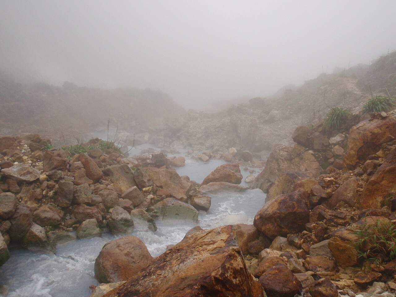 Steam rising from the greyish churning water of the Boiling Lake in Dominica's Morne Trois Pitons National Park