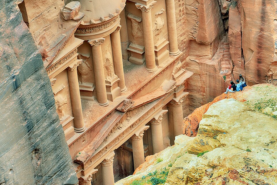 The rose-pink carved facade of Al-Khazneh Treasury framed by the narrow Siq canyon at Petra, Jordan