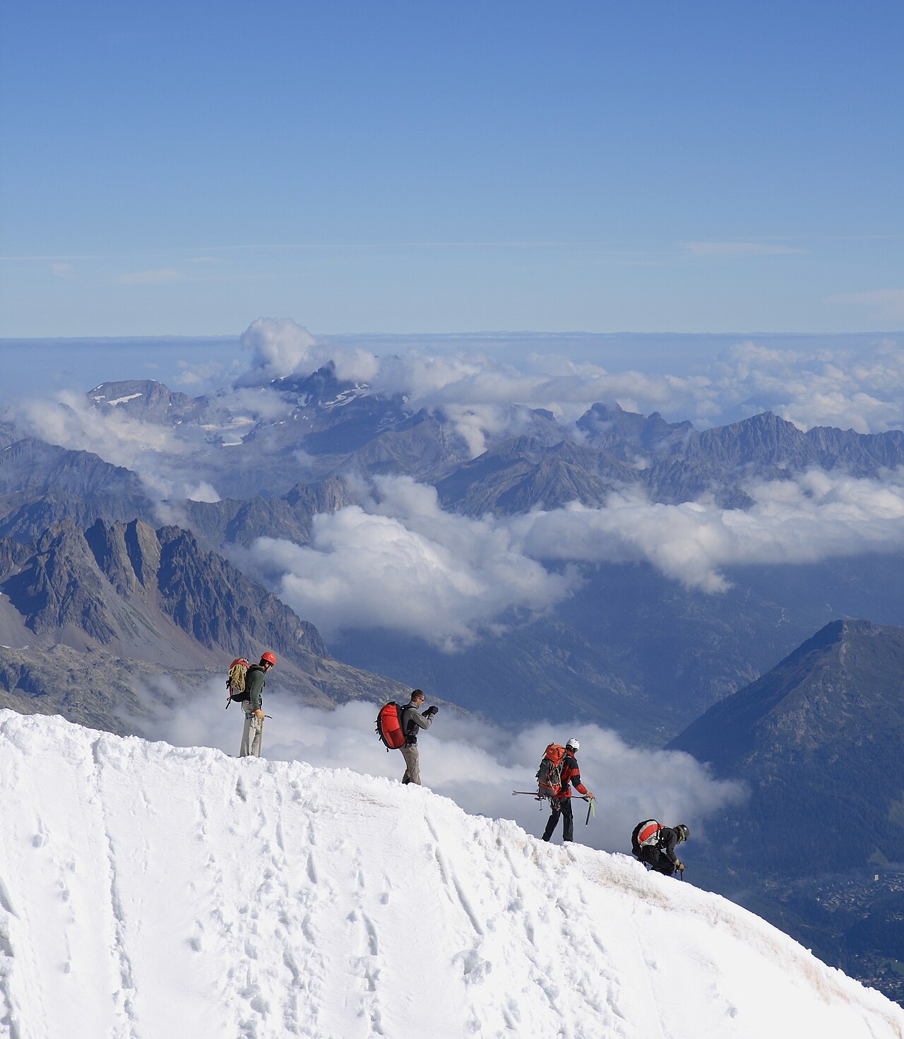 Alpinists on the rocky summit of the Aiguille du Midi above Chamonix, France, at 3,842 metres