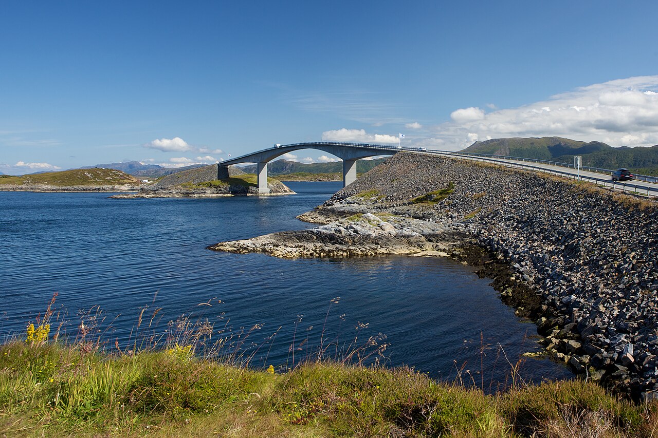 The curved Storseisundet Bridge on Norway's Atlantic Ocean Road, appearing to launch into the sky
