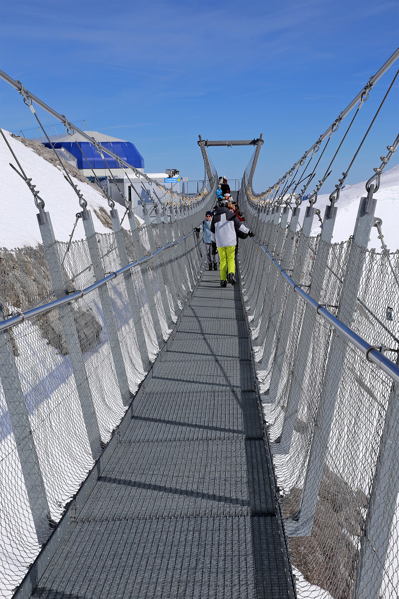The Titlis Cliff Walk, Europe's highest suspension bridge, clinging to a snowy cliff face in the Swiss Alps