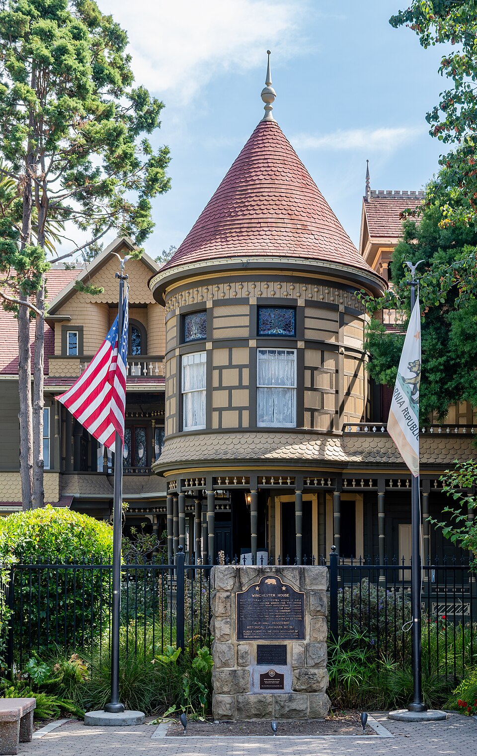 The exterior of the Winchester Mystery House in San Jose, California, a sprawling Victorian mansion with multiple turrets and additions