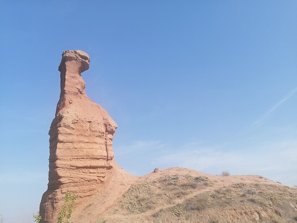 Colorful striped rock formations of Danxia landforms in Zhangye, China, showing layers of red and yellow geology