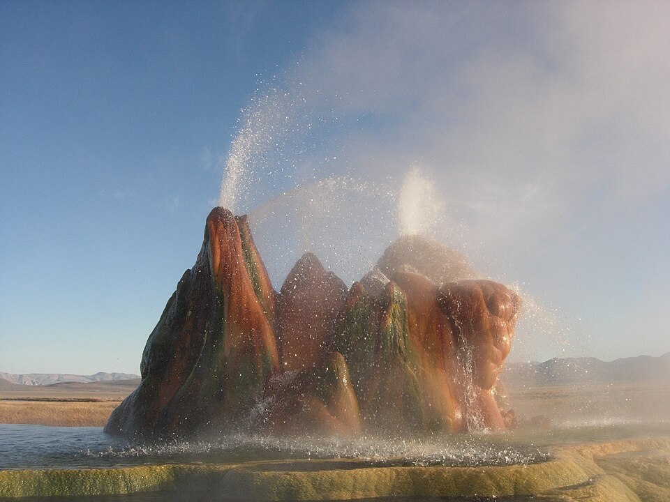 Fly Geyser on Fly Ranch in Nevada, a colorful mineral mound with hot water erupting from the top