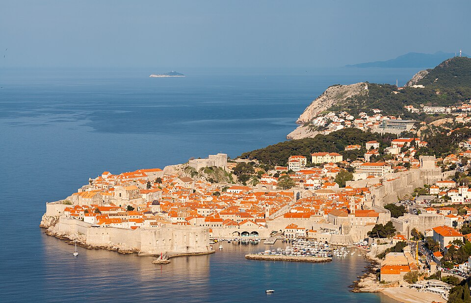 View across the terracotta rooftops of Dubrovnik's walled old town with the Adriatic Sea beyond