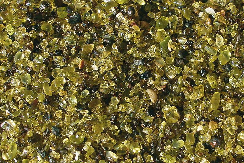Close-up of the olive-green olivine crystals that make up the sand at Papakolea Green Sand Beach in Hawaii