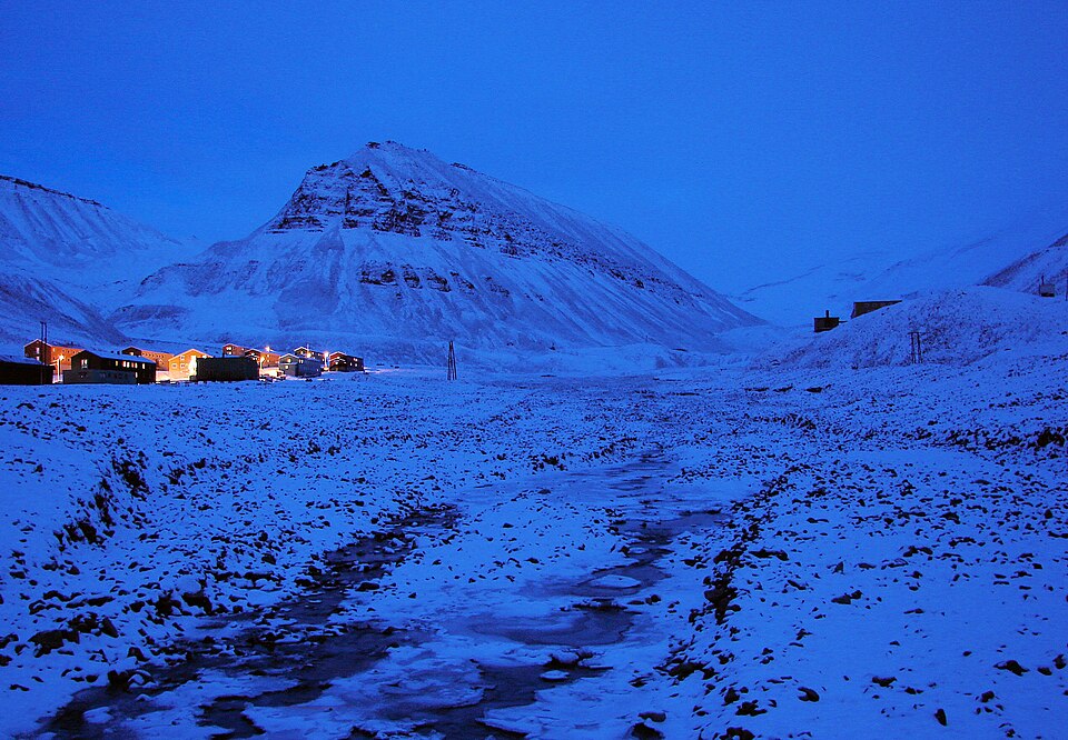 Deep blue twilight over the snow-covered town of Longyearbyen, Svalbard, during the polar night