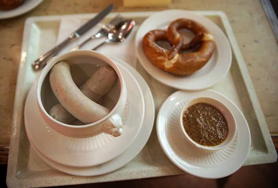 Traditional German soft pretzel and white sausage, part of the culinary tradition that dates back to medieval monastery bakeries