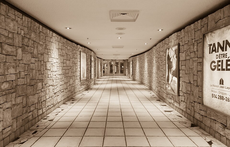 A bright, busy corridor in the Montreal RESO underground pedestrian tunnel network connecting thousands of businesses beneath the city streets