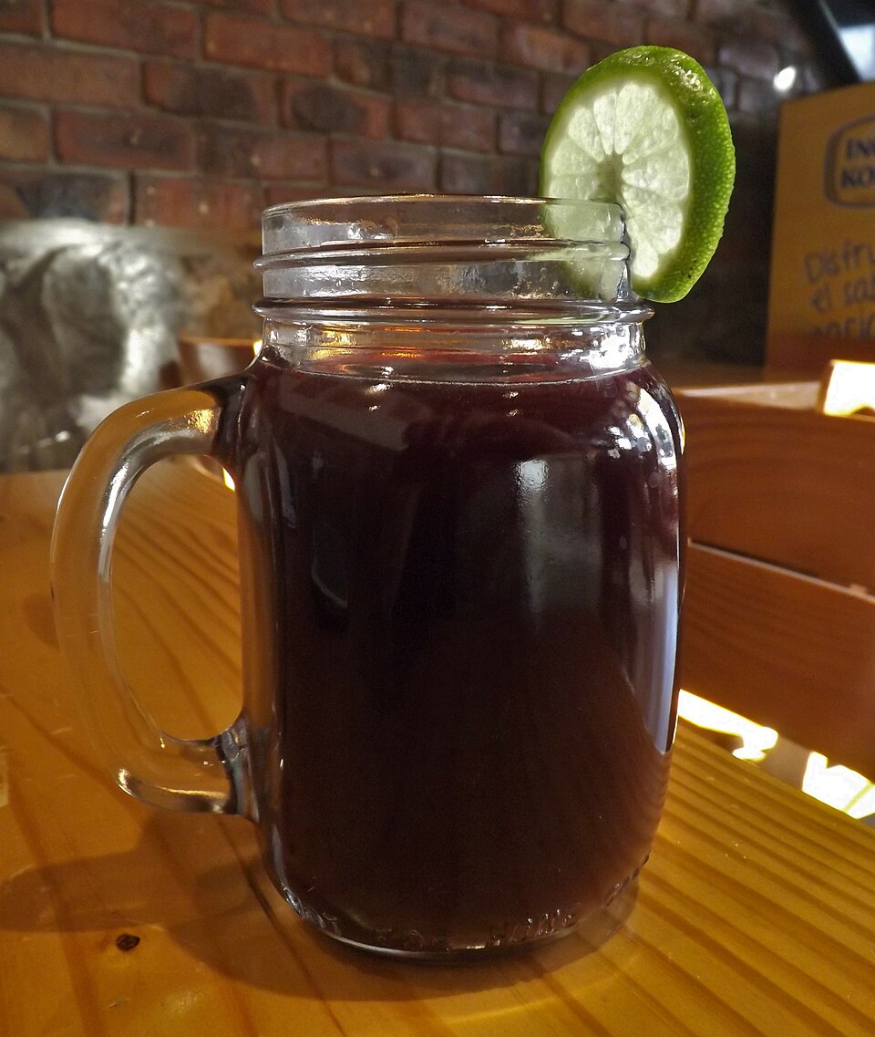 Tall glass of purple chicha morada, the traditional Peruvian corn drink, served chilled