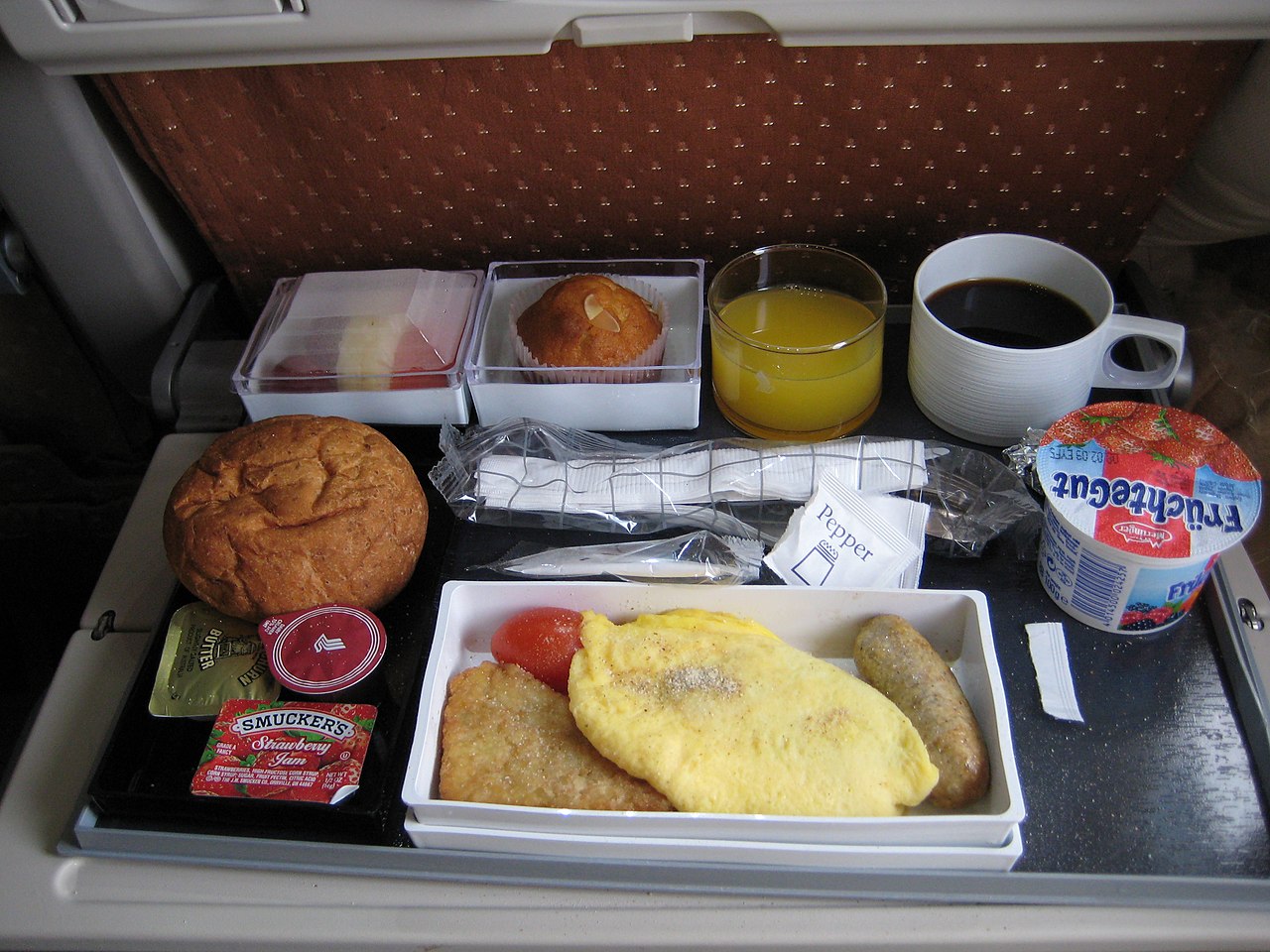 Singapore Airlines inflight meal of rice and accompaniments - the airline test-cooks dishes in a low-pressure chamber to compensate for altered taste perception at altitude